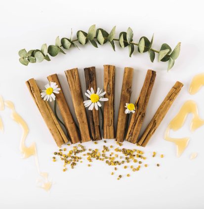 elevated-view-spices-flowers-honey-bee-pollen-white-surface